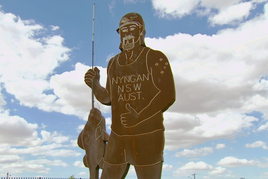 The Big Bogan is a five-metre-tall steel carving with a thumbs up, cap, mullet, and fishing rod.