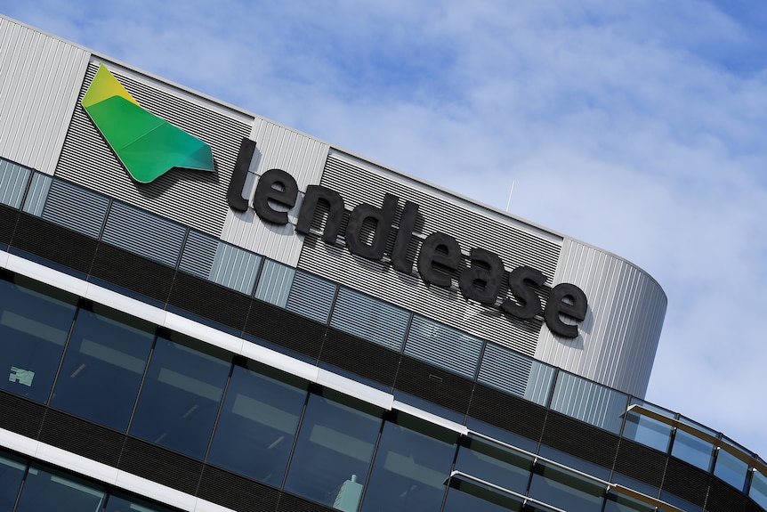 A sign on top of a building reads "lendlease". 