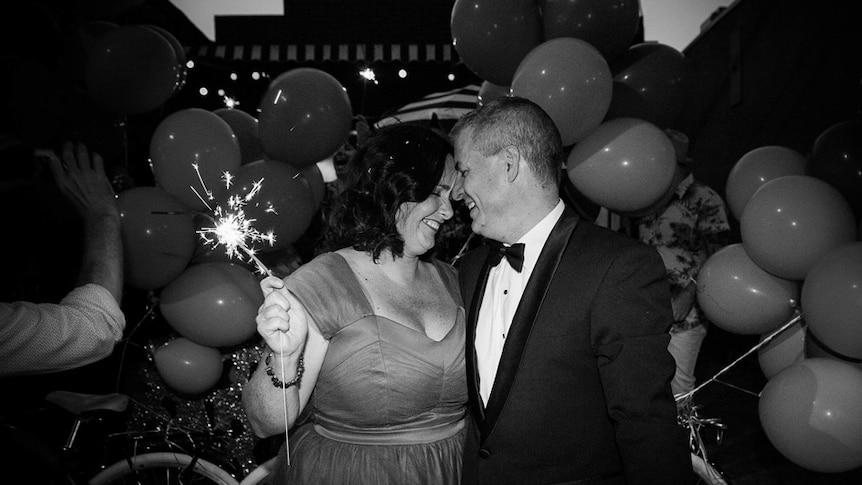 Catherine Deveny and her partner, surrounded by balloons, at their Love Party.