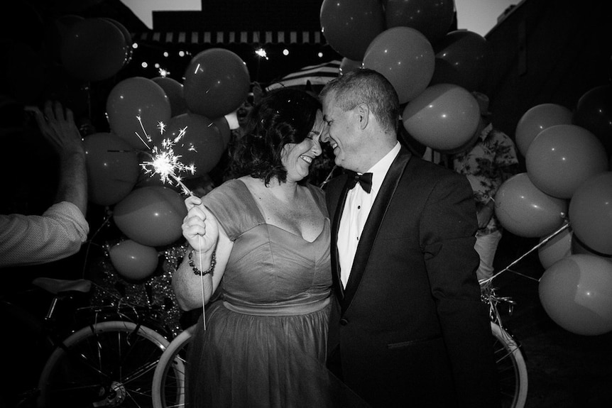 Catherine Deveny and her partner, surrounded by balloons, at their Love Party.
