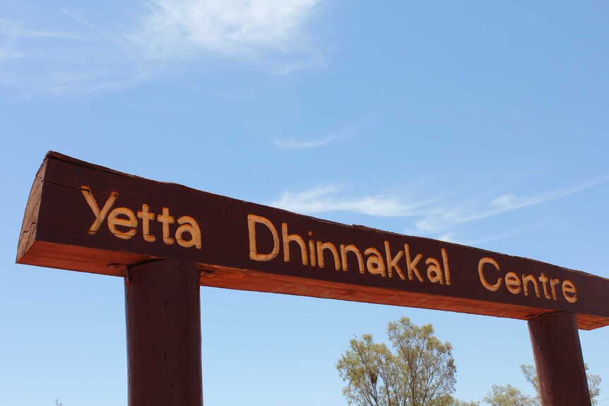 A wooden sign with Yetta Dhinnakkal Centre written on it.