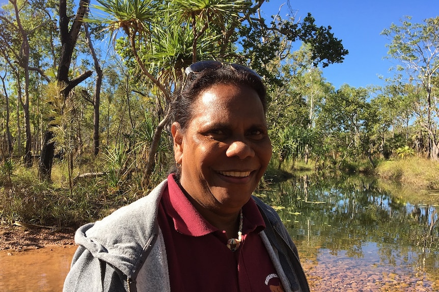 Martina Barry stands by a lake in a remote outstation.