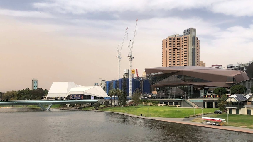 Dust rolling across the sky behind the River Torrens and Adelaide Convention Centre.