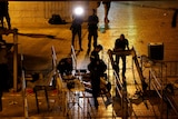 Israeli security forces remove metal detectors with lights at night.