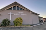 A church with the words 'Albany Baptist Church 'on the front