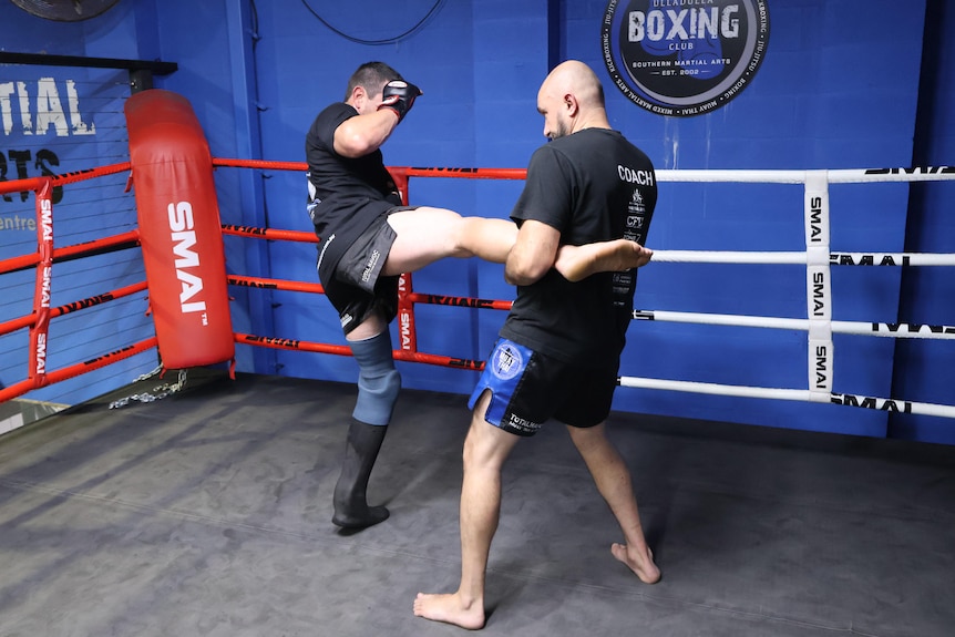 Two men in a ring for fight training.