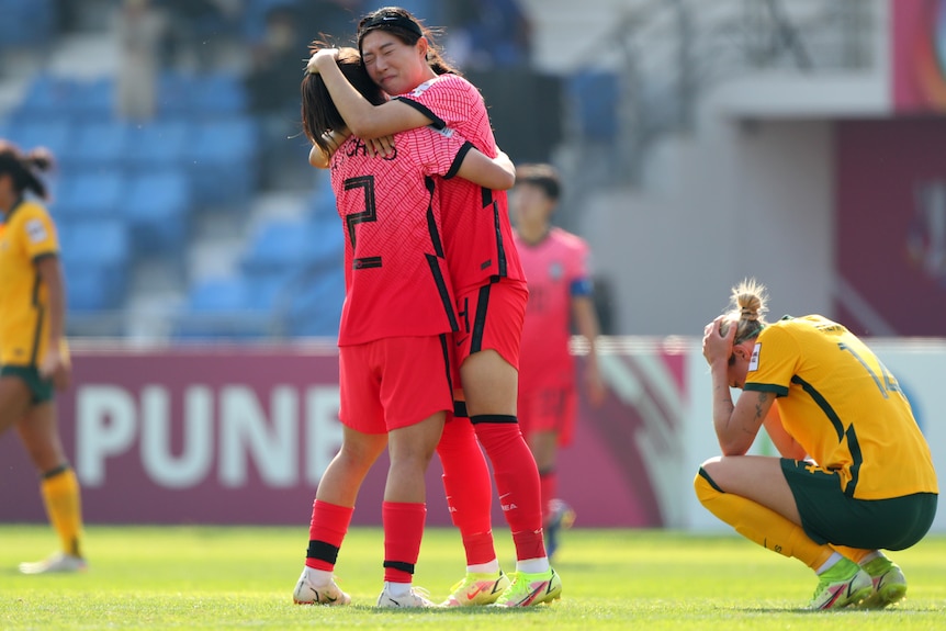  South Korea celebrate their 1-0 victory while Matildas' Alanna Kennedy shows dejection