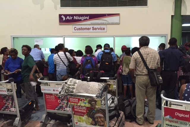 People line up at Port Moresby airport