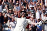 England batsman Ben Stokes spreads his arms, with bat in hand, as he screams. The English crowd screams behind him.