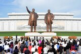 People visit the the statues of North Korea's founder Kim Il Sung and late leader Kim Jong Il