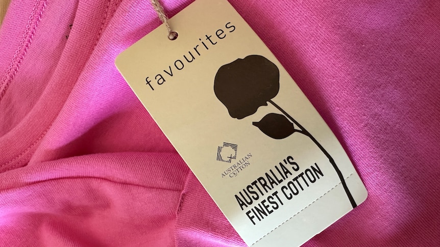A tag sits on a brightly coloured cotton tshirt it reads: favourites Australian Cotton Australia's finest cotton