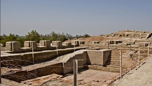 An archaeological excavation site shows unearthed building structures