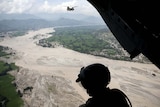 US Army Staff Sergeant Matthew Kingsbury looks down at floodwaters in the Swat Valley