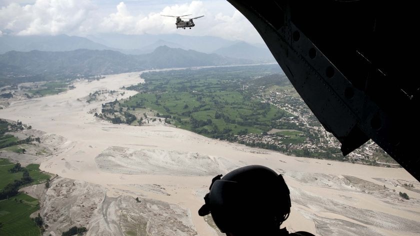 US Army Staff Sergeant Matthew Kingsbury looks down at floodwaters in the Swat Valley