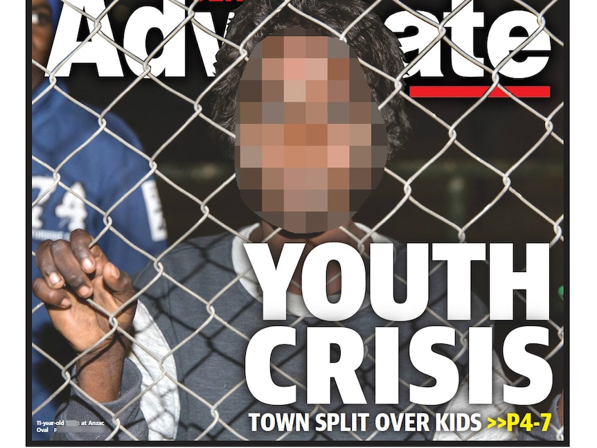 The pixelated front page of the Centralian Advocate of a 10-year-old boy holding onto a fence.