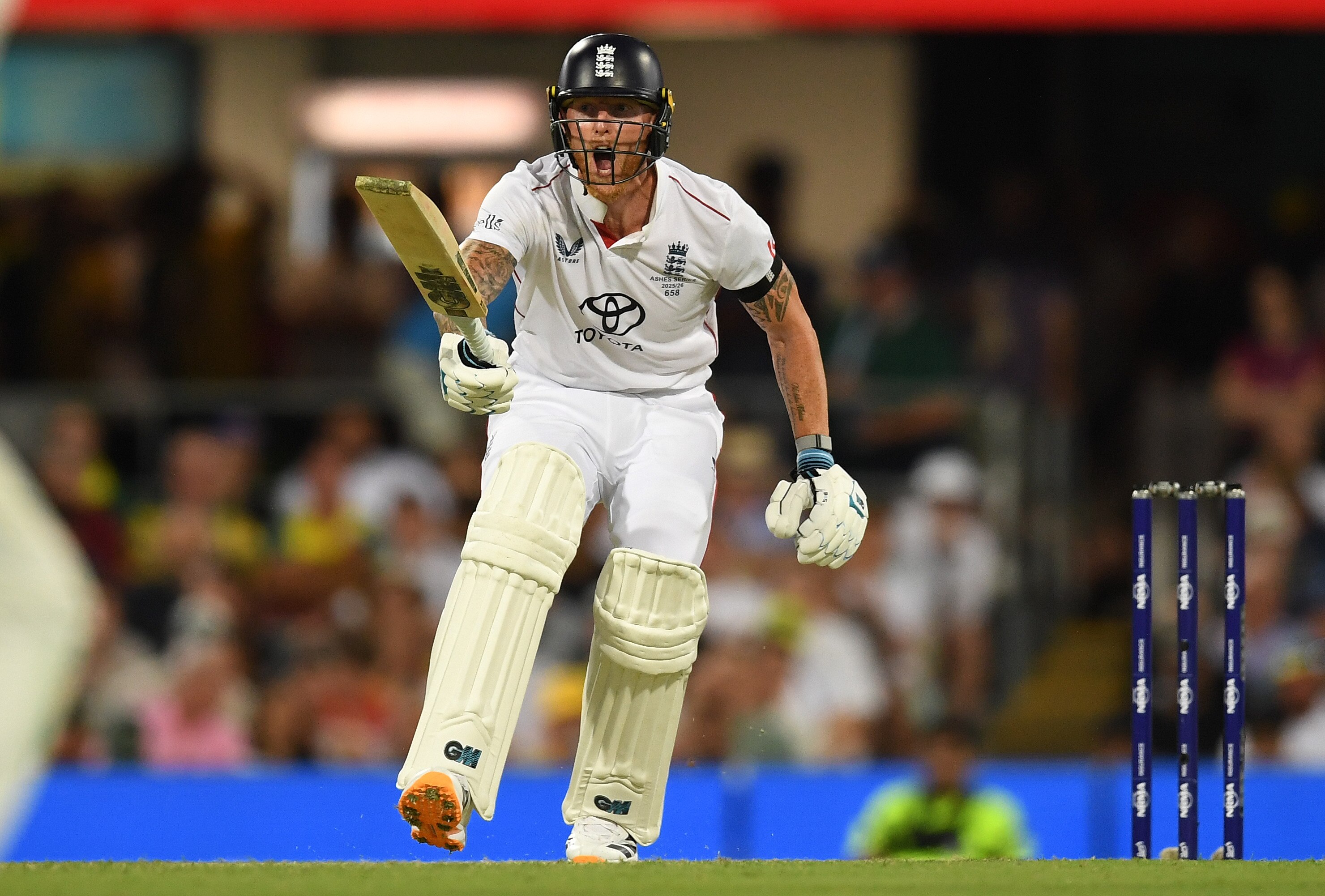 England batter Ben Stokes holds his bat up and shouts during a Test at the Gabba.