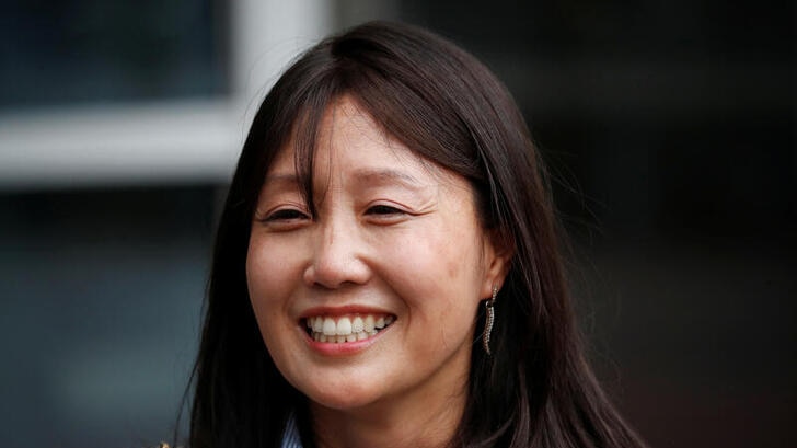 A photo of Kara Bos smiling after attending her trial in front of a court in Seoul, South Korea.