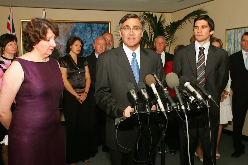 West Australian Premier Geoff Gallop speaks at a media conference flanked by wife Bev and son Leo with his cabinet behind him.