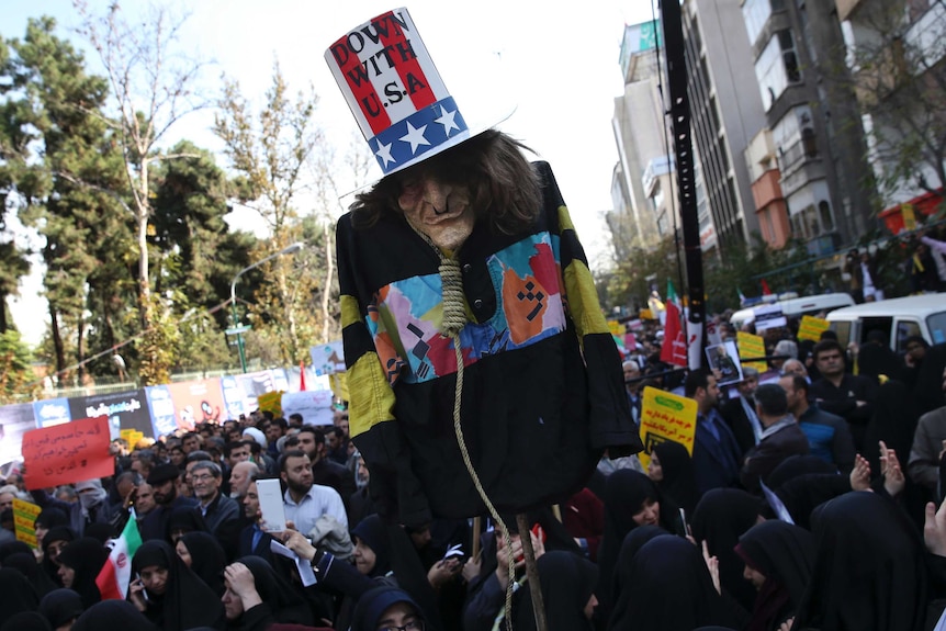 Protesters hold up an effigy of US government icon 'Uncle Sam' in Iran.