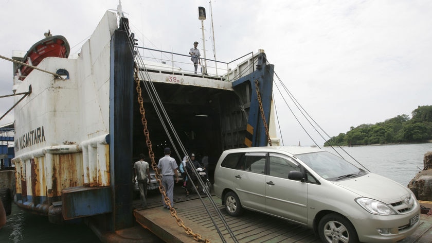 A ferry unloads cars in Merak, a busy port on the western tip of Java.