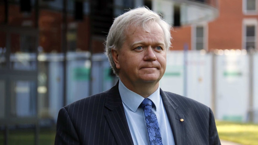 Brian Schmidt standing outside a building on the Australian National University campus.