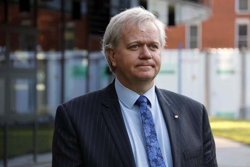 Brian Schmidt standing outside a building on the Australian National University campus.