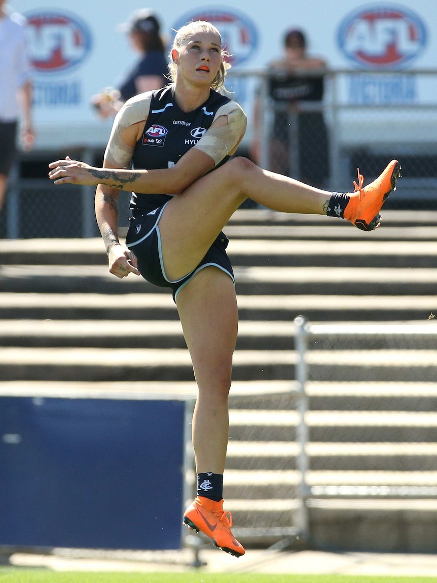 Tayla Harris lifts her leg as she kicks for goal in the AFL finals match against Fremantle