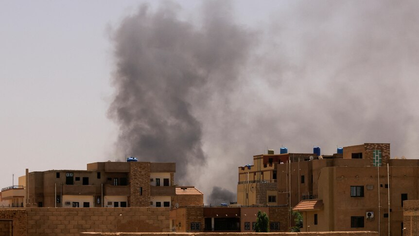 Smoke is seen rise from buildings during clashes between both forces.