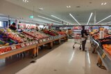 Shoppers in the fruit and vegetable aisle at Coles.