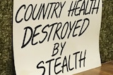 Sign reads 'county health destroyed by stealth'.