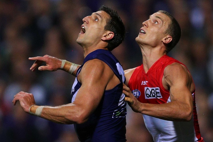 Eyes on the prize ... Matthew Pavlich (L) and Ted Richards contest for the ball