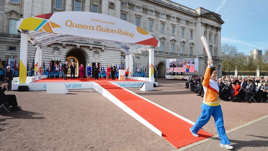 Anna Meares carries the Gold Coast Commonwealth Games relay baton at Buckingham Palace