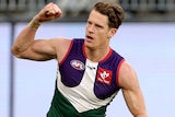 Fremantle Dockers player Matt Taberner pumps his fist in the air in celebration after kicking a goal.