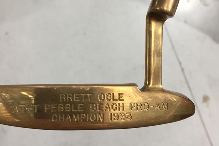 A gold-plated putter engraved with Brett Ogle's name.
