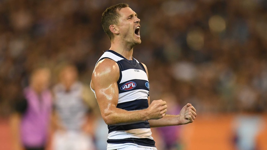 Joel Selwood pumps his fists as he screams out in celebration.