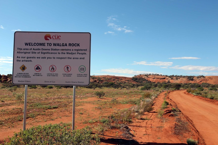 A Walga Rock welcome sign and red dirt road.