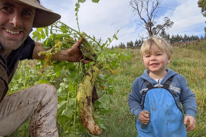 Photo of a adult and a child with a radish