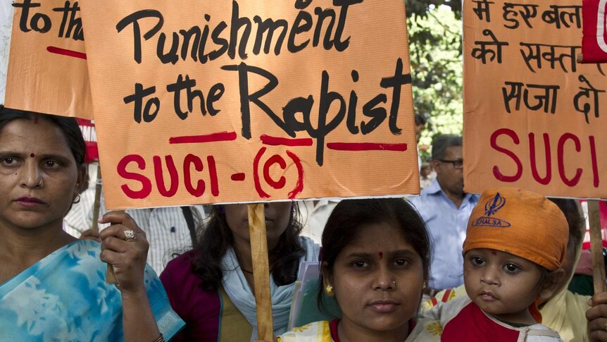 Activists hold up placards as they protest the rape of a five-year-old girl in New Delhi.
