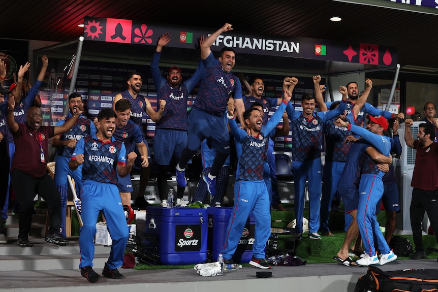 Players and staff on the Pakistan bench leap into the air in celebration of the winning runs