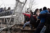 Asylum seekers open the gate at the Greek-Macedonian borders during a protest.