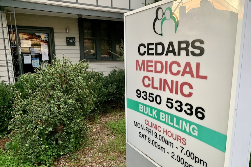 A closed sign is displayed in the glass door at the entrance to Cedars Medical Clinic.