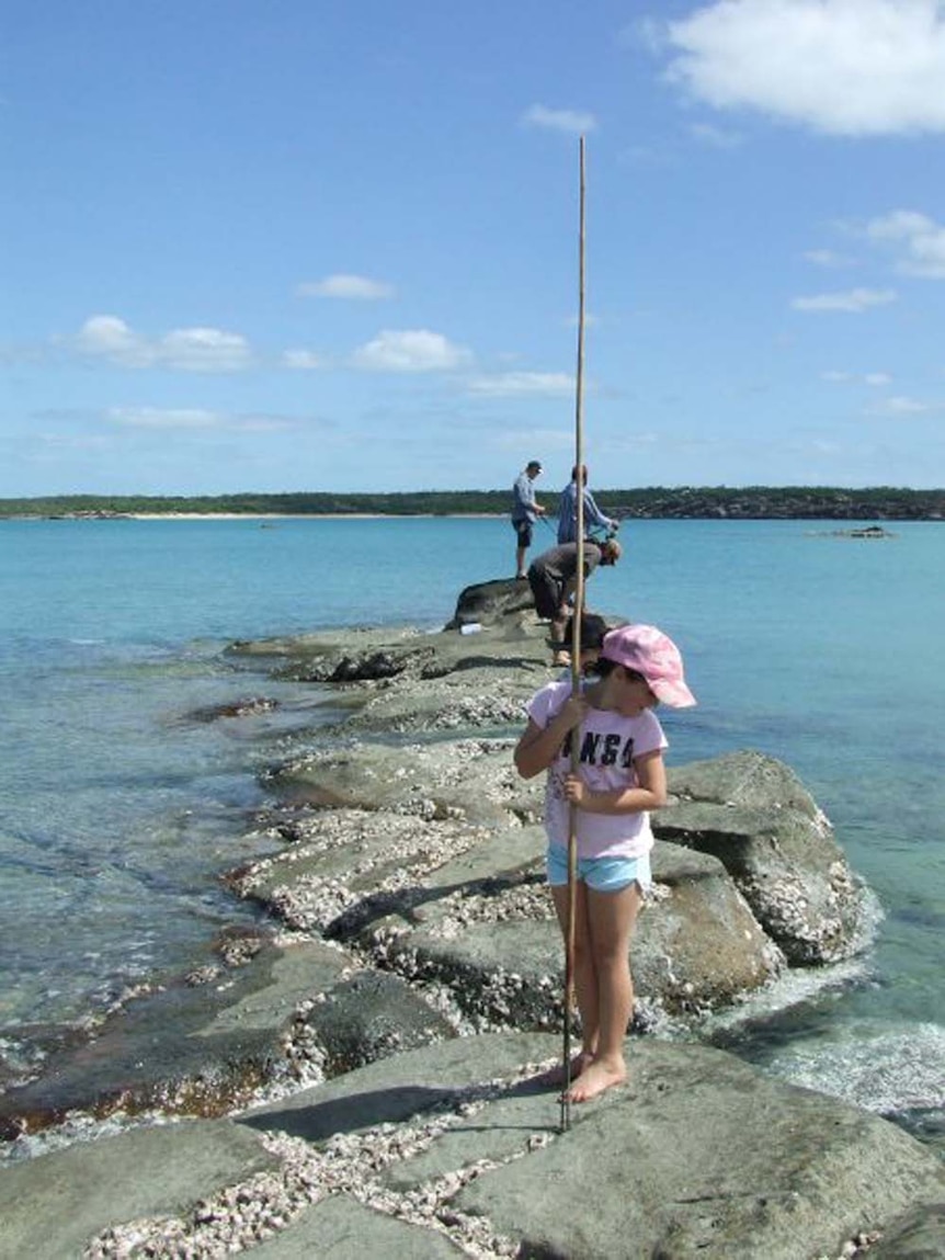 girl with a spear fishing
