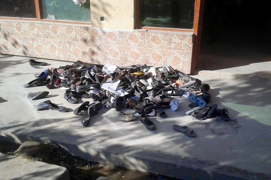 The abandoned shoes of Afghan schoolgirls lie on the ground outside a school after the earthquake.