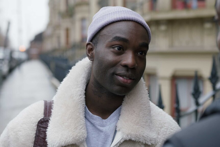 A scene from the TV series I May Destroy You with Paapa Essiedu out on a London street talking to another man