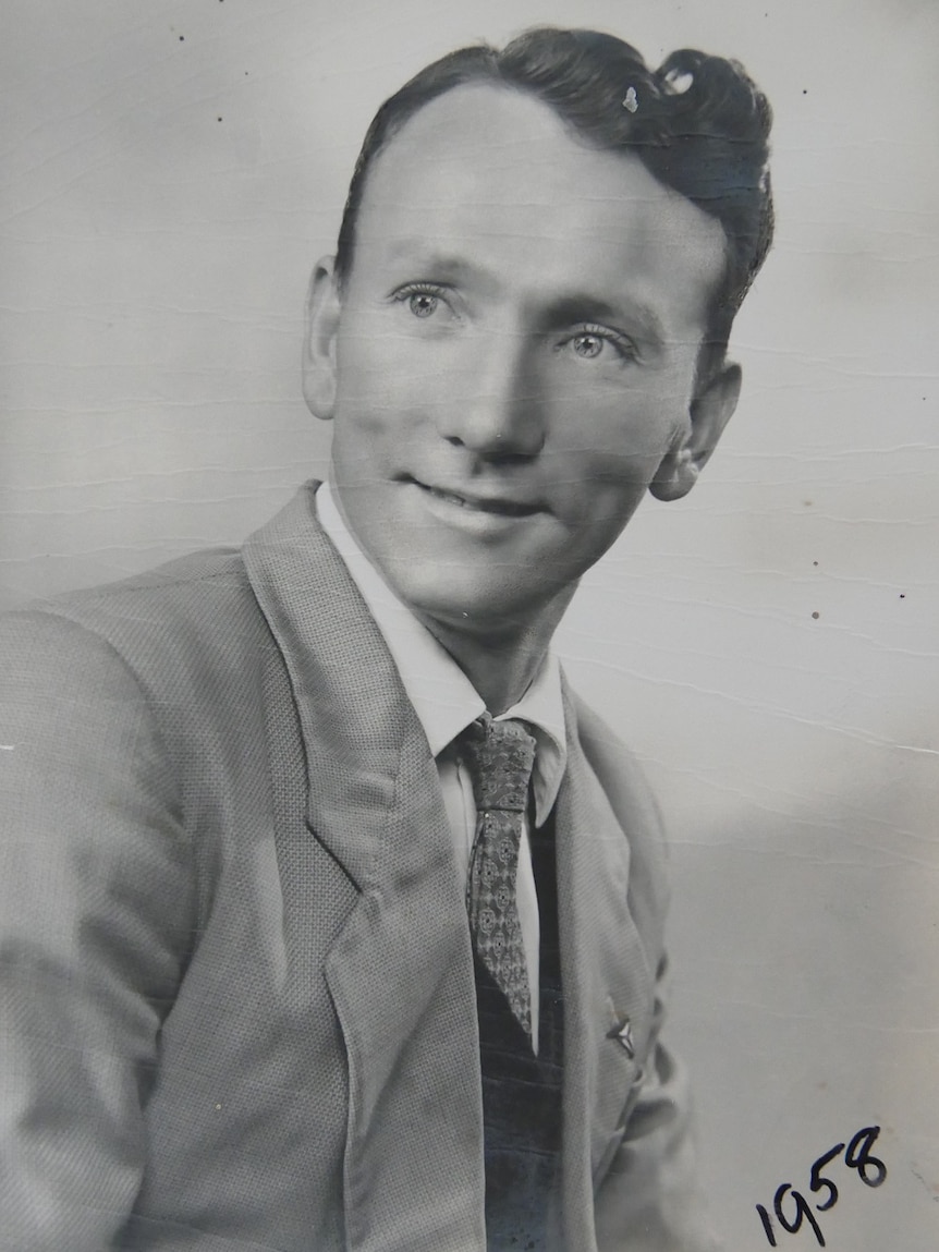 A black and white head and shoulders portrait of a young man from 1958.