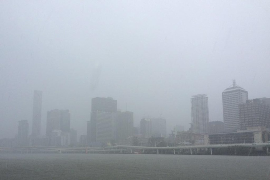 Brisbane CBD barely visible through the rain