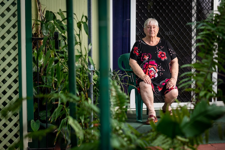Lynn Archibald sits on the deck outside her caravan at the Malak Caravan Park.