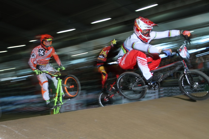 Sam Willoughby rides his BMX in front of two other riders