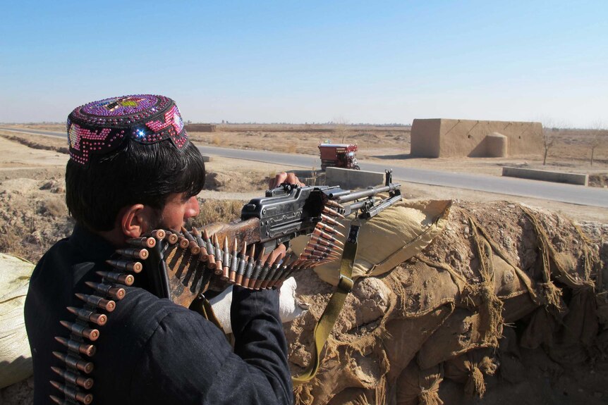 A member of the Afghan Local Police keeps watch in the Marjah district of Helmand Province