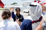 Saudi Arabian astronaut Rayyanah Barnawi waves to family and friends as she arrives at the Kennedy Space Center.